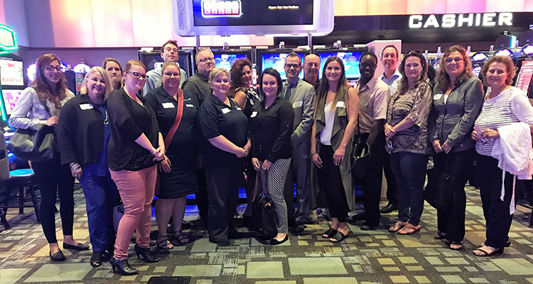 Guests gather for group photo in casino before slot tournament.